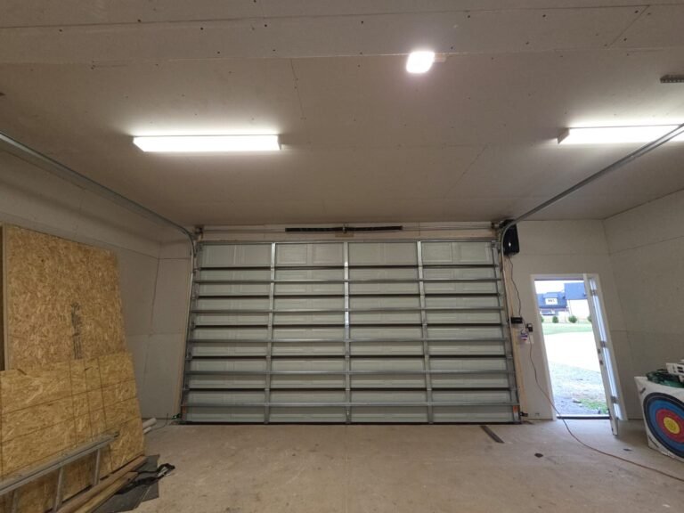 New garage door with opener installed inside a finished garage