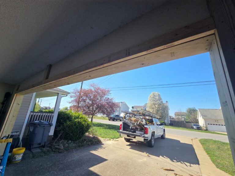 Crew truck parked outside a home during a garage door replacement