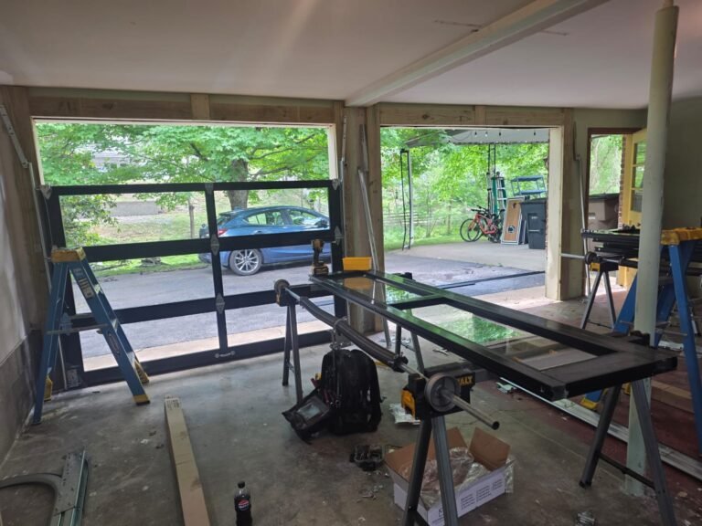 Black aluminum and glass garage door installed in a home garage