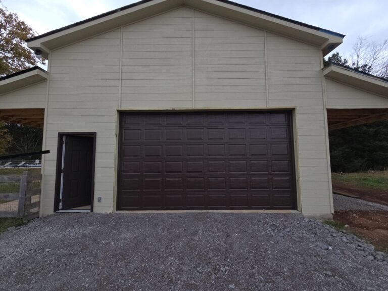 New dark walnut raised-panel garage door on a newly built detached garage